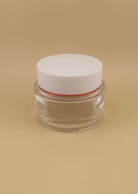 Garrafa transparente, tampa branca com moldura em ouro para produtos de cuidados com a pele