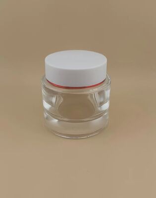 Garrafa transparente, tampa branca com moldura em ouro para produtos de cuidados com a pele